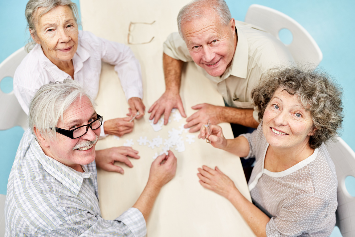 Happy Seniors Play Puzzle Together